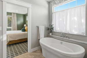 Bathroom with ensuite bath and a freestanding tub