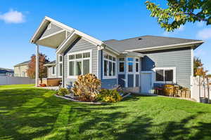 Back of house featuring a patio area and roof with shingles