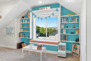Recreation room featuring carpet flooring and vaulted ceiling