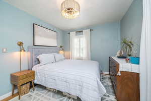 Bedroom with baseboards and wood finished floors