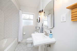 Bathroom featuring light tile patterned floors and shower / bath combo