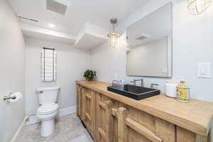 Half bath featuring vanity and recessed lighting