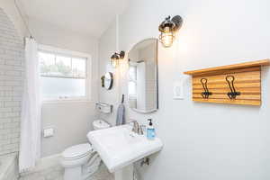 Bathroom featuring tile patterned flooring and shower / bath combination with curtain