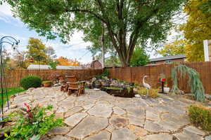 Fenced backyard with a patio area