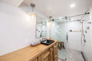 Full bath featuring vanity and a shower stall