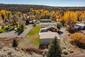 View from above of property featuring a heavily wooded area