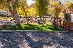 View of green lawn with a wooden deck