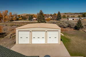 Detached garage with a view of countryside and a mountain view