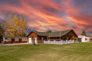 View of front of property with driveway and stone siding