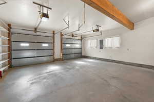 Garage featuring electric panel and a garage door opener