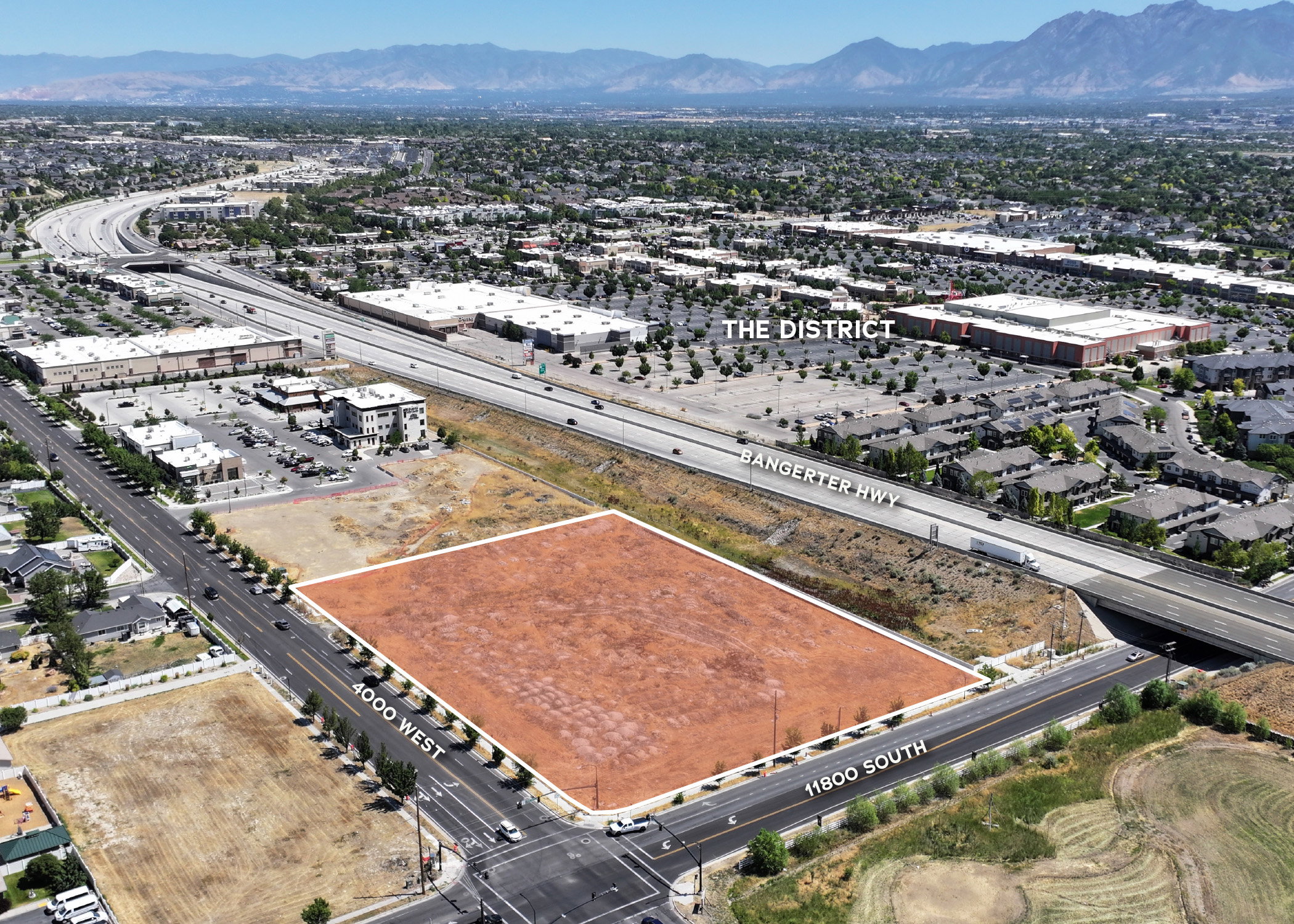 Aerial view of property's location with a mountainous background and property parcel outlined