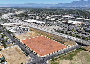 Aerial view of property's location with a mountainous background and property parcel outlined