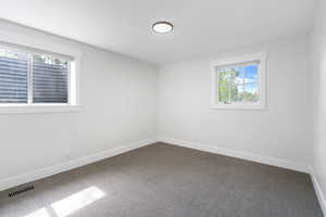 Unfurnished room featuring carpet flooring and baseboards