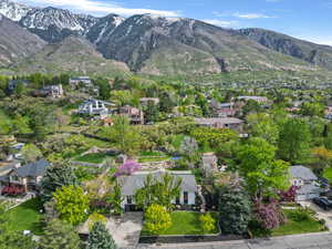 Aerial overview of property's location featuring a mountainous background and nearby suburban area