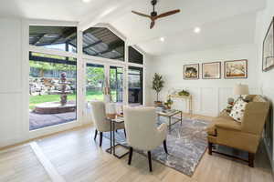 Interior space featuring light wood-style flooring, wainscoting, a decorative wall, and ceiling fan