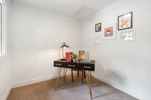 Home office with plenty of natural light, carpet floors, and attic access