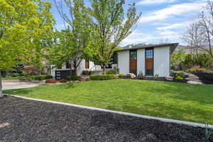 View of front of home featuring a front lawn and brick siding