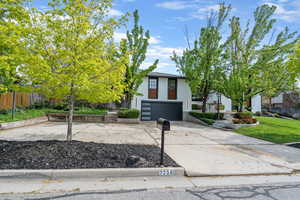 Contemporary home with concrete driveway, stucco siding, and a garage
