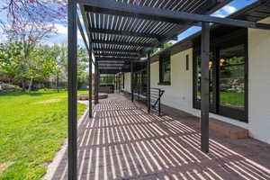 View of patio / terrace with a hot tub and a pergola