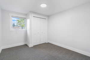 Unfurnished bedroom featuring carpet floors and a closet