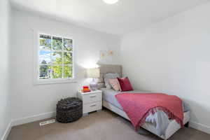Bedroom with carpet and baseboards