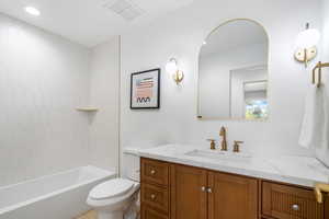 Bathroom with vanity, shower / tub combination, and recessed lighting
