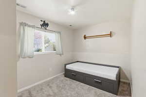 Unfurnished bedroom featuring carpet and baseboards