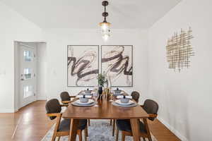 Dining room with light wood-style flooring and baseboards