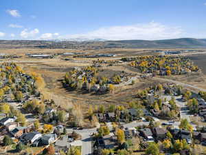 Aerial view of property's location featuring nearby suburban area and a mountainous background