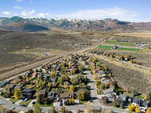 Aerial view of property's location with mountains and nearby suburban area