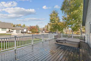 Deck with a residential view and a lawn