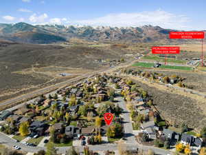 Aerial view of property's location featuring a mountain backdrop and nearby suburban area
