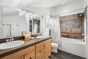 Bathroom with shower / bath combo and double vanity
