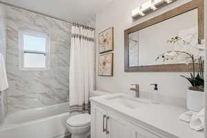 Bathroom with vanity and shower / bath combo