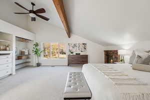 Bedroom featuring a fireplace, light colored carpet, and ceiling fan