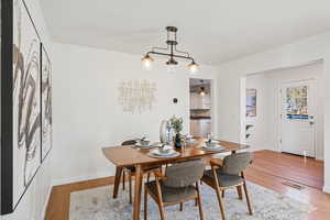 Dining area featuring light wood-type flooring and baseboards