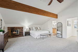 Bedroom featuring light colored carpet, a fireplace, and ceiling fan