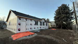 View of side of property featuring a shingled roof