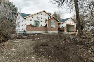 View of property exterior featuring brick siding and a shingled roof
