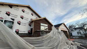View of side of home featuring brick siding