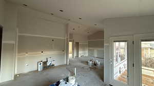 Unfurnished room with vaulted ceiling