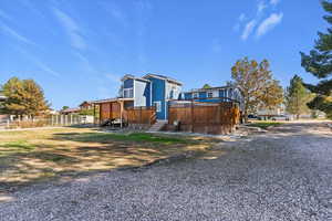 View of property exterior with a wooden deck