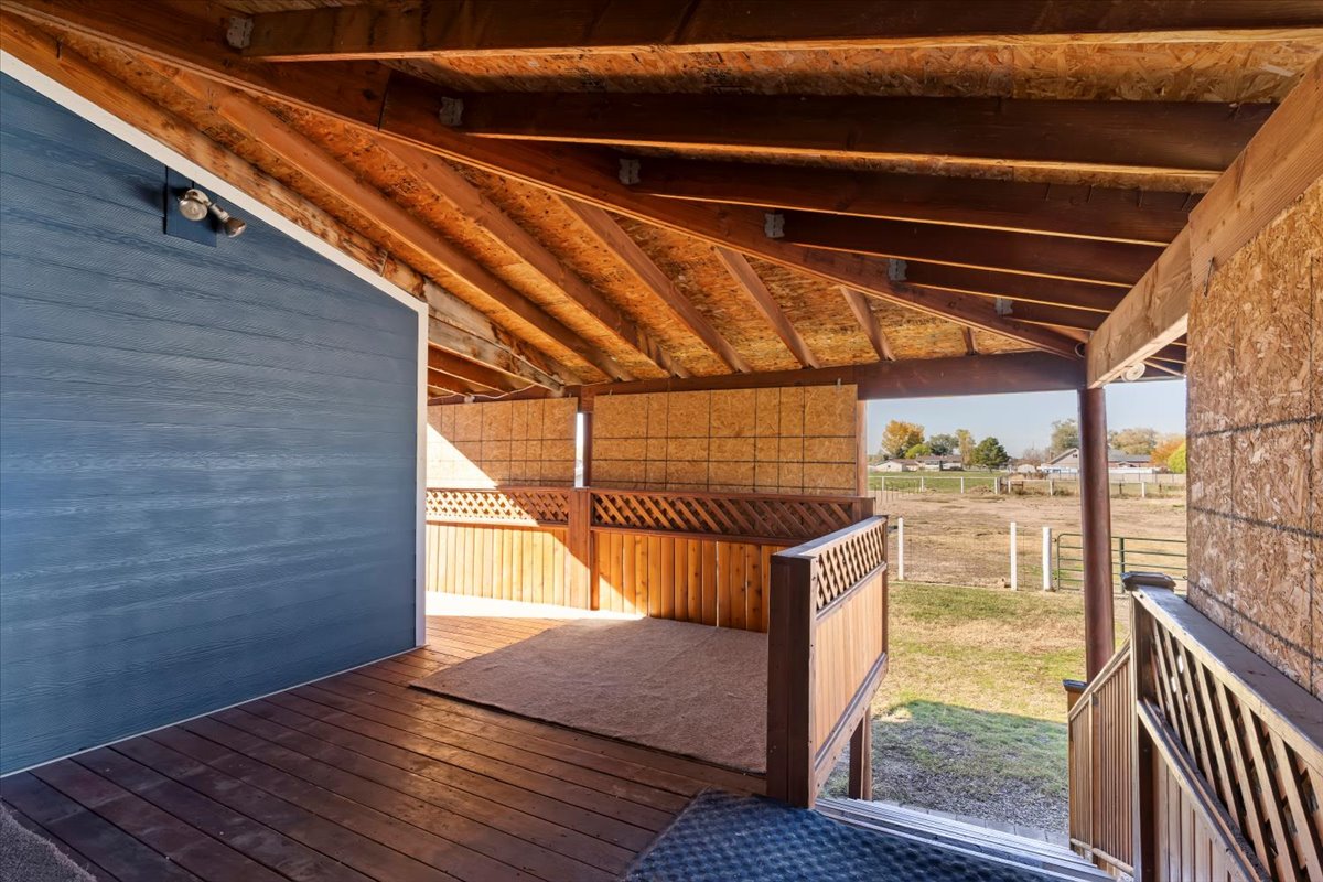 Wooden terrace featuring a view of countryside