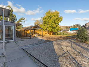 Fenced backyard featuring a patio