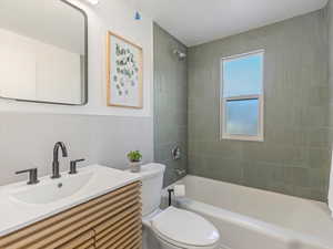 Bathroom with vanity and shower / tub combination