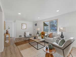Living room featuring healthy amount of natural light, light wood-style flooring, and recessed lighting