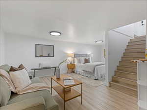 Bedroom featuring light wood finished floors and baseboards