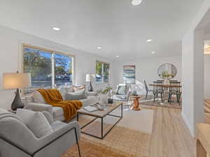 Living area featuring light wood finished floors and recessed lighting