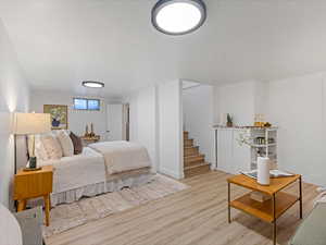 Bedroom featuring light wood finished floors and baseboards
