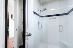 Bathroom featuring a stall shower and wood finished floors